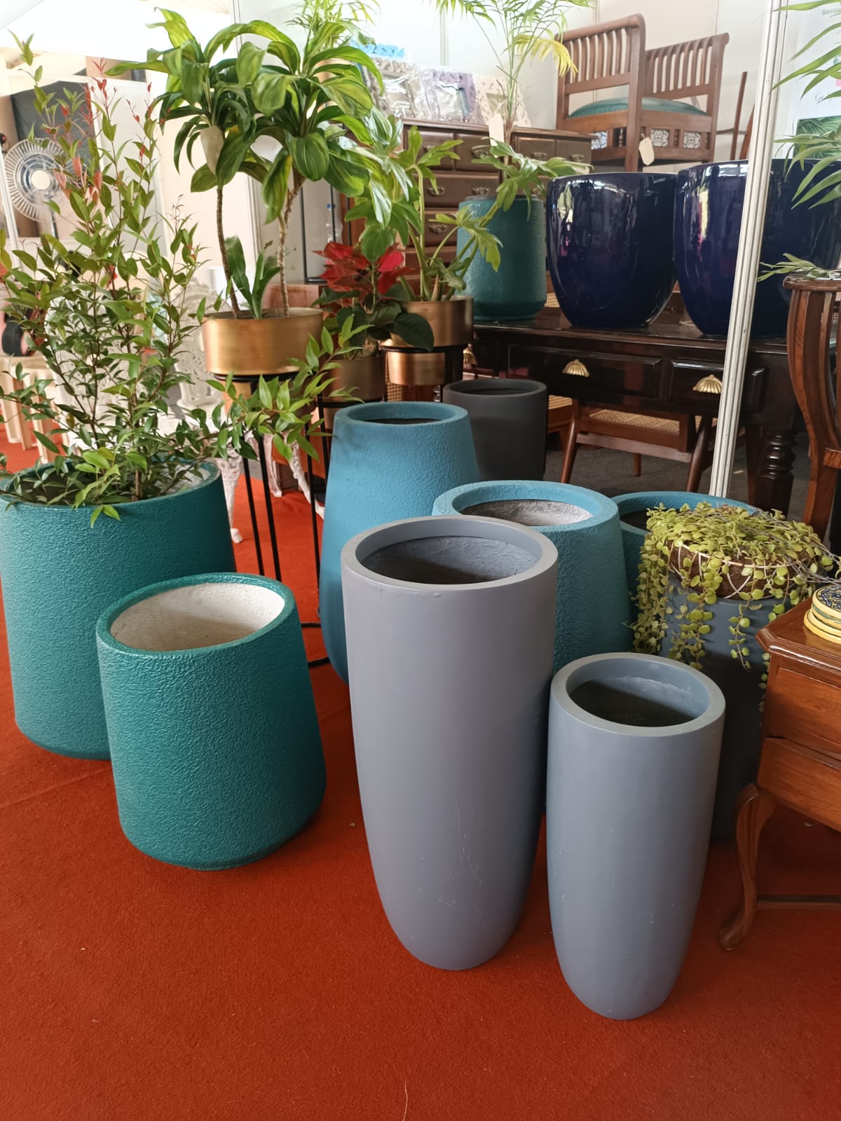 Ceramic and polymer planters with plants at the Go Green Decor studio